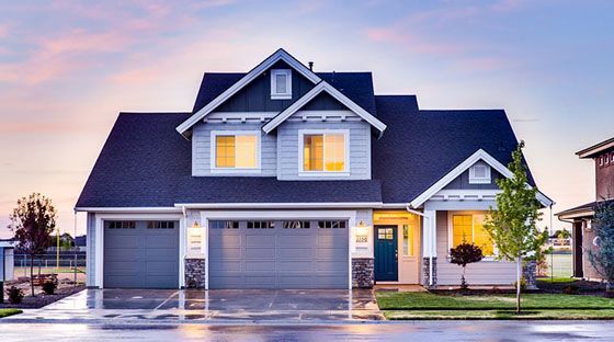 A house with a driveway and garage in front of it.